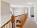Bright and airy hallway with neutral walls, wood railing, and carpet floors at 2460 Switch Grass Way, Castle Rock, CO 80109