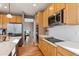 Contemporary kitchen featuring stainless appliances, ample counter space, and light wood cabinets at 2460 Switch Grass Way, Castle Rock, CO 80109