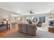 Bright and open living room featuring large windows, a ceiling fan, and a neutral color palette at 2460 Switch Grass Way, Castle Rock, CO 80109
