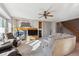 Cozy living room with a fireplace, large windows, and comfortable seating at 2460 Switch Grass Way, Castle Rock, CO 80109