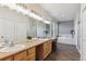 Luxurious main bathroom featuring dual vanity, tub, and ample natural light at 2460 Switch Grass Way, Castle Rock, CO 80109