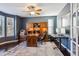 Spacious home office with custom built-ins, dark wood floors, and ample natural light at 2460 Switch Grass Way, Castle Rock, CO 80109