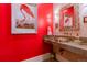 Unique half bath with bright red walls, contemporary vanity and decorative artwork at 1745 N Emerson St, Denver, CO 80218