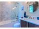 Bathroom with marble tiling, a glass shower, and a dark wood vanity offers a serene space at 1745 N Emerson St, Denver, CO 80218