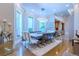 Elegant dining room featuring modern lighting, large windows, and a dining table that seats 8 people at 1745 N Emerson St, Denver, CO 80218