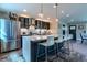 Modern kitchen with stainless steel appliances, a large island, and stylish pendant lighting at 1745 N Emerson St, Denver, CO 80218