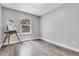 Bright, empty bedroom featuring light-colored walls, wood flooring, and a sunlit window at 11757 W Tufts Pl, Morrison, CO 80465