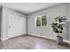 Bedroom with wood floors, slider closet doors, and a plant near a window at 11757 W Tufts Pl, Morrison, CO 80465