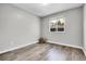Empty bedroom with wood floors and natural light from a window at 11757 W Tufts Pl, Morrison, CO 80465