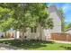 Well-maintained home featuring a green lawn and mature tree that provides shade and enhances curb appeal at 11757 W Tufts Pl, Morrison, CO 80465