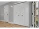 Hallway featuring a closet with bi-fold doors and light wood floors at 11757 W Tufts Pl, Morrison, CO 80465