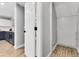 Hallway leading to a modern kitchen with stainless steel appliances and stylish cabinetry at 11757 W Tufts Pl, Morrison, CO 80465