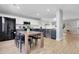 Bright, open kitchen and dining area with stainless steel appliances and adjoining living space at 11757 W Tufts Pl, Morrison, CO 80465