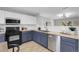 Renovated kitchen boasts stainless steel appliances, butcher block countertops, and stylish two-tone cabinets at 11757 W Tufts Pl, Morrison, CO 80465