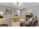 Bright living room featuring hardwood floors, modern decor, and comfortable seating arrangement at 11757 W Tufts Pl, Morrison, CO 80465