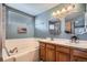 Lovely bathroom features a double sink vanity, a large soaking tub and tiled shower at 5251 Altura St, Denver, CO 80239