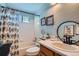 Charming bathroom featuring a shower-tub combo, and vanity with vessel sink at 5251 Altura St, Denver, CO 80239