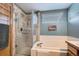 The bathroom features a shower with glass doors, a soaking tub and an oversized window at 5251 Altura St, Denver, CO 80239