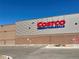 This image features a Costco Wholesale store exterior with its iconic logo and parking lot on a bright, sunny day at 5251 Altura St, Denver, CO 80239