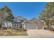 Well-maintained two-story home with a three-car garage and manicured front yard at 5251 Altura St, Denver, CO 80239