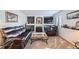 Cozy living room features a fireplace, plush carpeting, and comfortable leather seating at 5251 Altura St, Denver, CO 80239