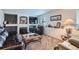 Cozy living room features a fireplace, plush carpeting, and comfortable leather seating at 5251 Altura St, Denver, CO 80239