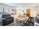 Relaxing living room features plush carpeting, comfortable leather seating, and natural light at 5251 Altura St, Denver, CO 80239
