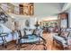 Bright living room with hardwood floors, staircase and wrought iron glass-top coffee table at 5251 Altura St, Denver, CO 80239