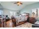This cozy main bedroom features a unique ceiling fan and large windows that provide natural light at 5251 Altura St, Denver, CO 80239