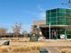 This image features the exterior of the Montebello Recreation Center on a clear day with a sign and modern architecture at 5251 Altura St, Denver, CO 80239
