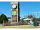 This image features a Town Square monument with various business signs, under a clear blue sky at 5251 Altura St, Denver, CO 80239