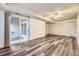 Finished basement with wood-look flooring, recessed lighting, and sliding glass door to outdoor space at 8208 S High Ct, Centennial, CO 80122