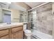 Updated bathroom featuring tiled shower with sliding glass doors and single sink vanity at 8208 S High Ct, Centennial, CO 80122