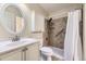 Bright bathroom with tiled shower, modern vanity, and storage cabinet for convenience at 8208 S High Ct, Centennial, CO 80122