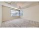 This bedroom features a neutral carpet, classic chandelier, and windows that bring in natural light at 8208 S High Ct, Centennial, CO 80122