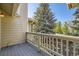 Exterior deck with white wood railing offering views of the community landscaping at 8208 S High Ct, Centennial, CO 80122