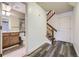 Entryway featuring vinyl floors, staircase, and access to an updated bathroom at 8208 S High Ct, Centennial, CO 80122