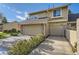 Two-story home featuring a two-car garage with brick accents and landscaping at 8208 S High Ct, Centennial, CO 80122