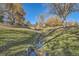 Scenic view of lush landscaping with winding creek at 8208 S High Ct, Centennial, CO 80122
