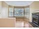 Cozy sitting area with a fireplace, hardwood floors and large windows at 8208 S High Ct, Centennial, CO 80122
