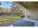 Back patio with room for seating, landscaping, and tree in the back at 8208 S High Ct, Centennial, CO 80122