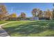 Outdoor tennis courts with dark fencing, surrounded by mature trees and green grass, offering a scenic sports facility at 8208 S High Ct, Centennial, CO 80122