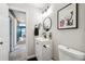 Contemporary bathroom featuring stylish fixtures, a black faucet, and an eye-catching mirror at 1225 S Oneida St # 248, Denver, CO 80224