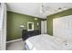 Olive-painted bedroom featuring a ceiling fan, ample closet space, and a stylish dresser at 1225 S Oneida St # 248, Denver, CO 80224