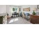 Light-filled bedroom featuring a piano, desk and a window with sheer curtains at 1225 S Oneida St # 248, Denver, CO 80224