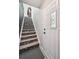 Bright entryway showcases a decorative staircase with patterned treads and a glass paneled door at 1225 S Oneida St # 248, Denver, CO 80224