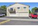 Exterior view of the home with two garage doors and a balcony at 1225 S Oneida St # 248, Denver, CO 80224