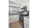 Updated kitchen featuring stainless steel appliances, white cabinets, and granite countertops at 1225 S Oneida St # 248, Denver, CO 80224