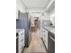 Bright kitchen with stainless steel fridge leading into dining area and stylish decor throughout at 1225 S Oneida St # 248, Denver, CO 80224