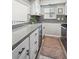 Well-lit kitchen with granite countertops, modern appliances, and stylish gray backsplash tiles at 1225 S Oneida St # 248, Denver, CO 80224